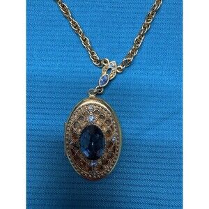 1928 Jewelry Gold Tone Oval Locket Necklace w/ Blue Stone Filigree & Crystal